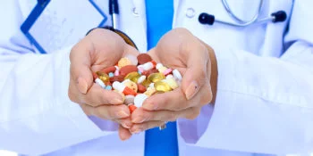 doctor holding prescription drugs