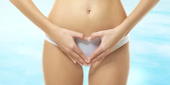 Young woman holding hands in heart shape
