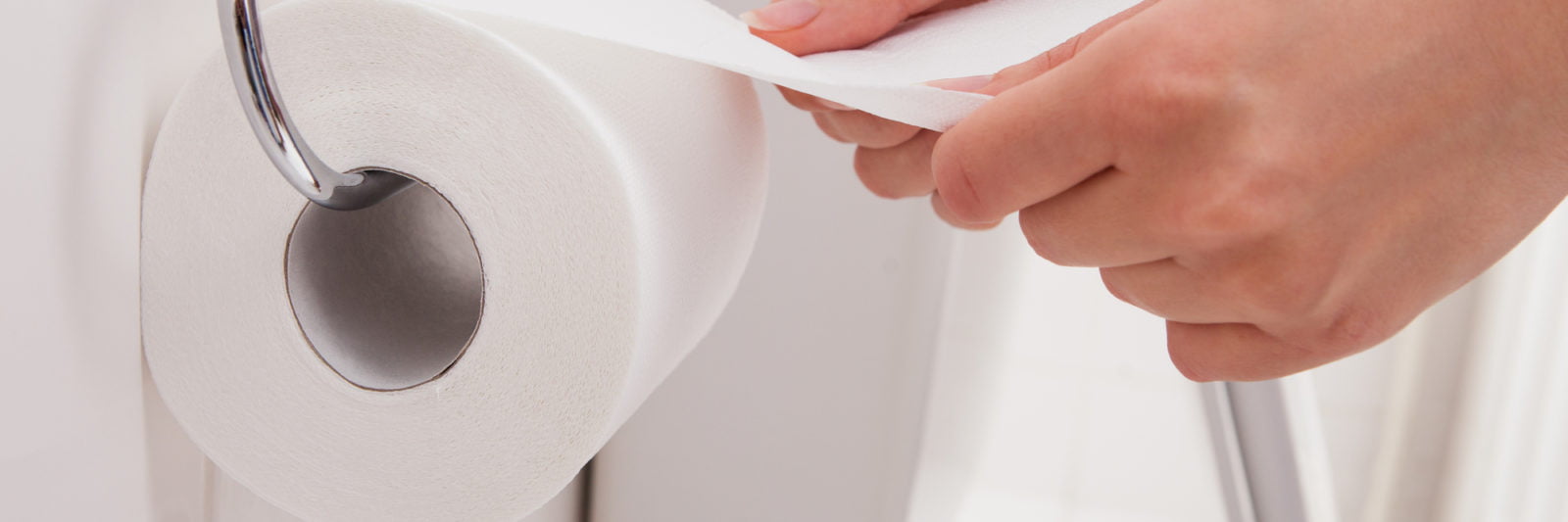 Close-up Of A Person's Hand Using Toilet Paper