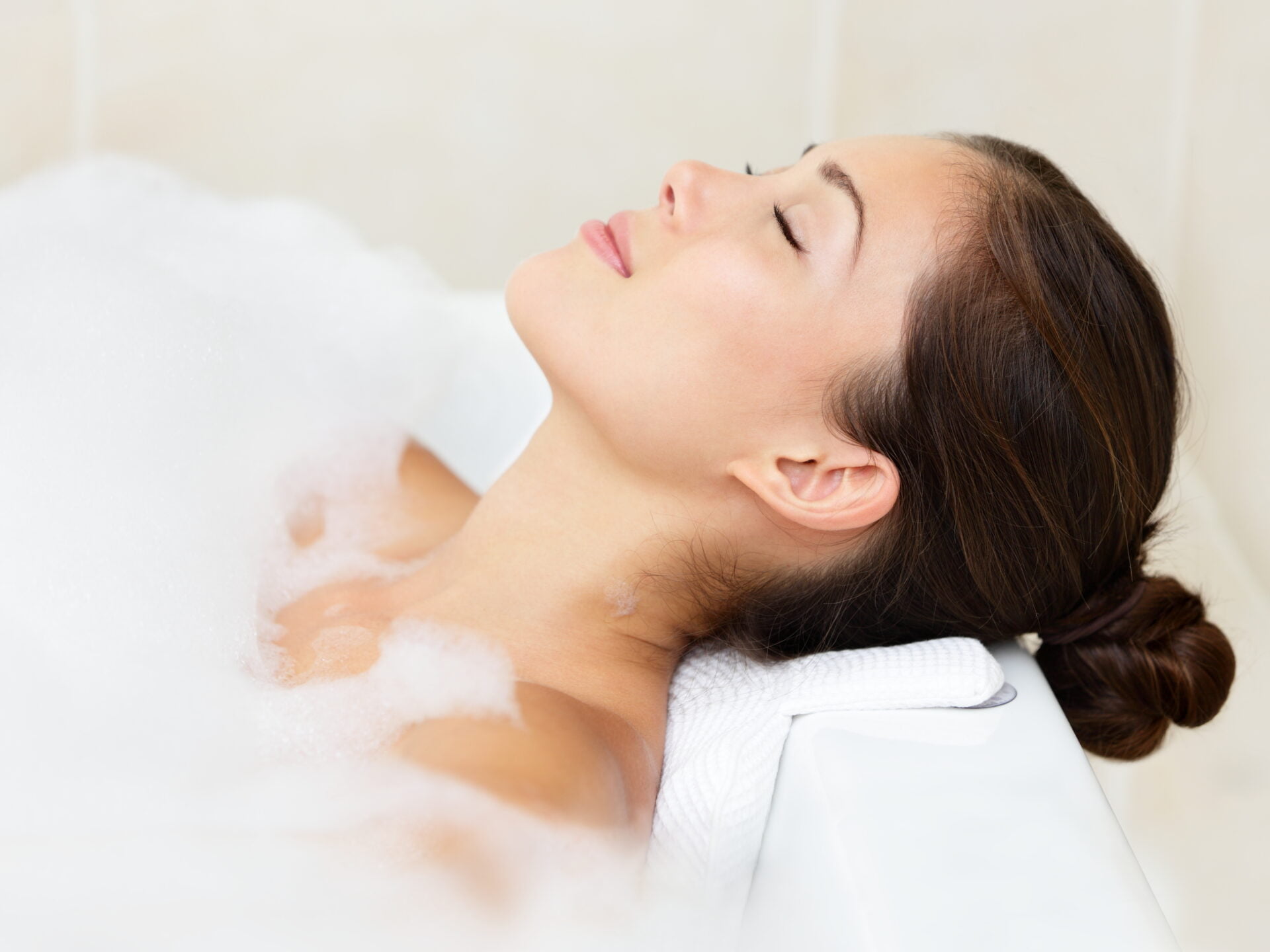 female in bathroom relaxing in a bubble bath made for sensitive skin