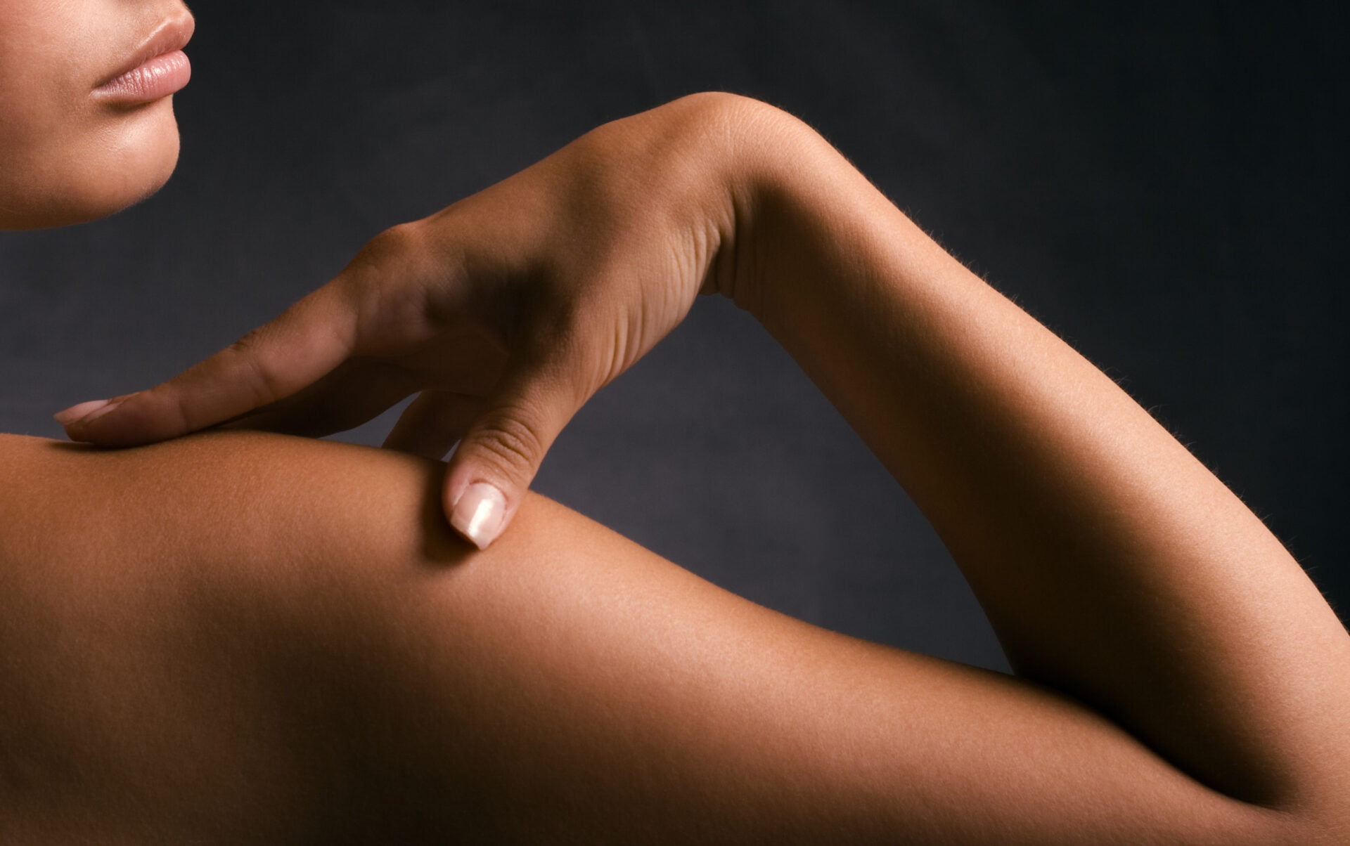 Tan woman who has applied non-toxic self tanning products