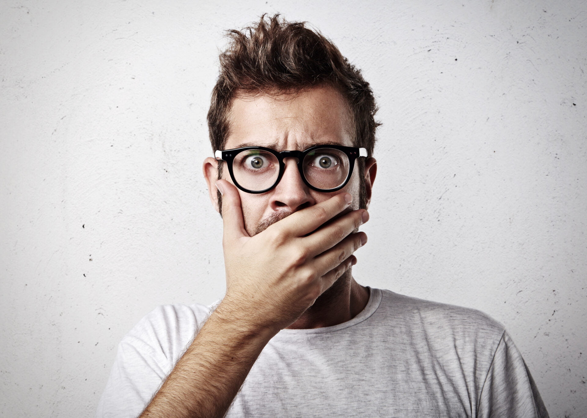 Portrait of a surprised young man wearing eyeglasses