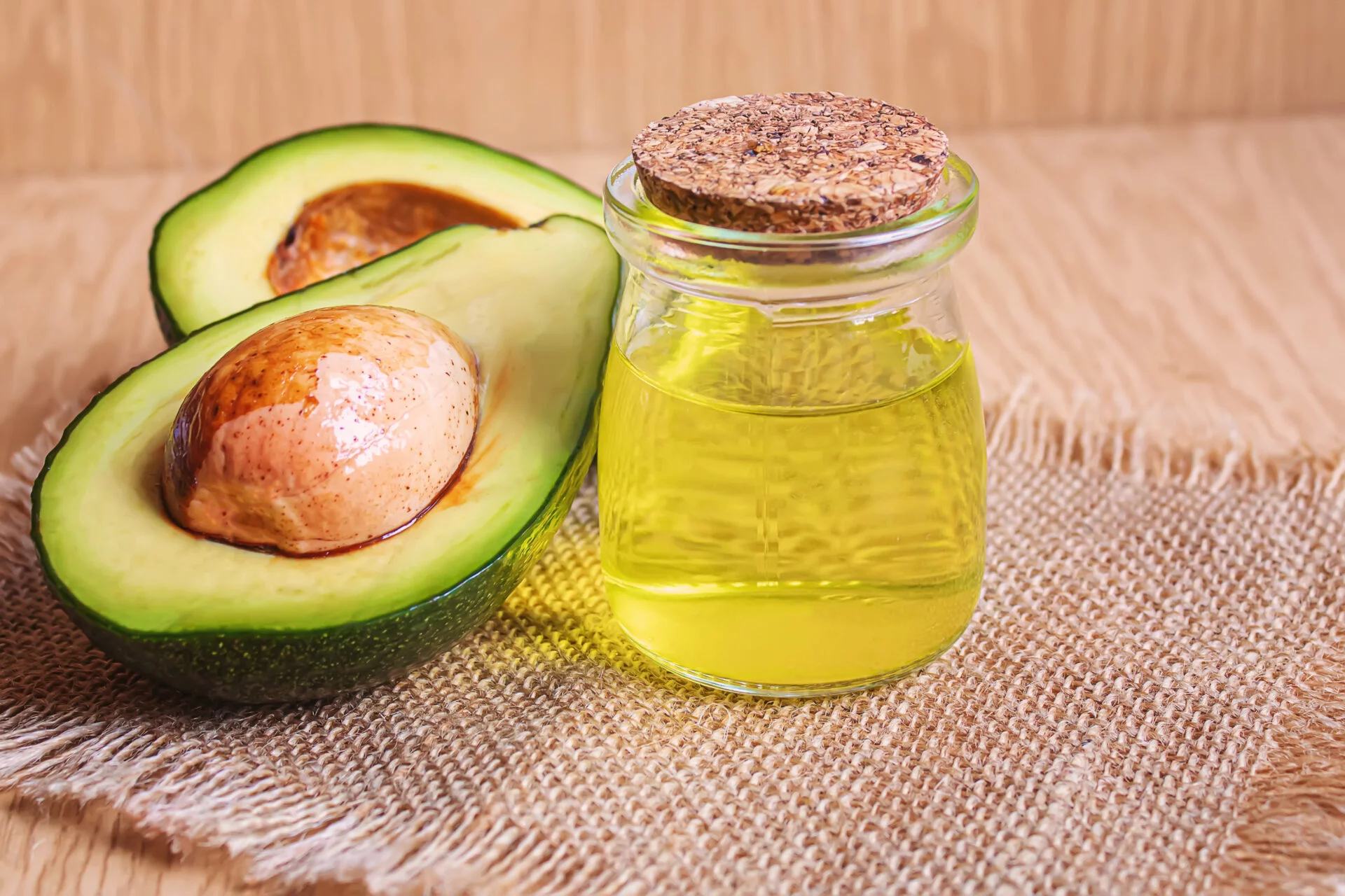 Avocado and avocado oil on wooden background. Selective focus.food