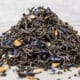 Earl Grey tea leaves on white wood tabletop