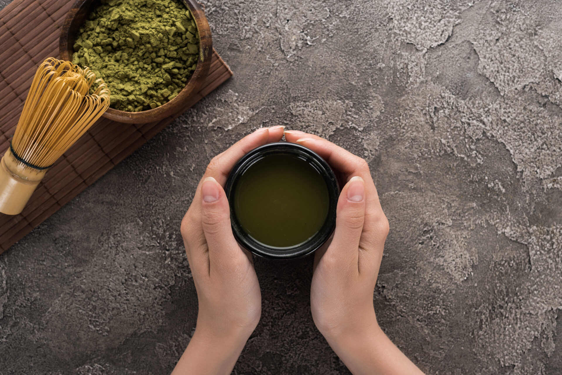 Woman holds matcha tea. Green Tea Tested for PFAS "Forever Chemicals" and put into a guide