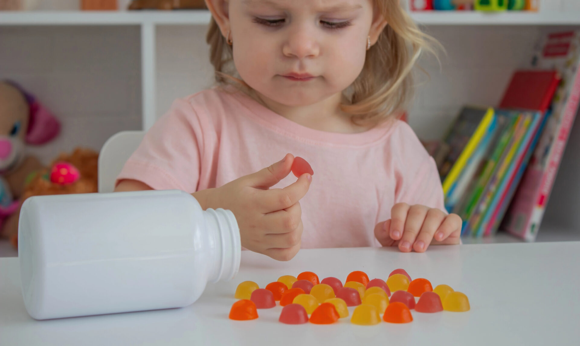 Young girl about to take her multivitamins