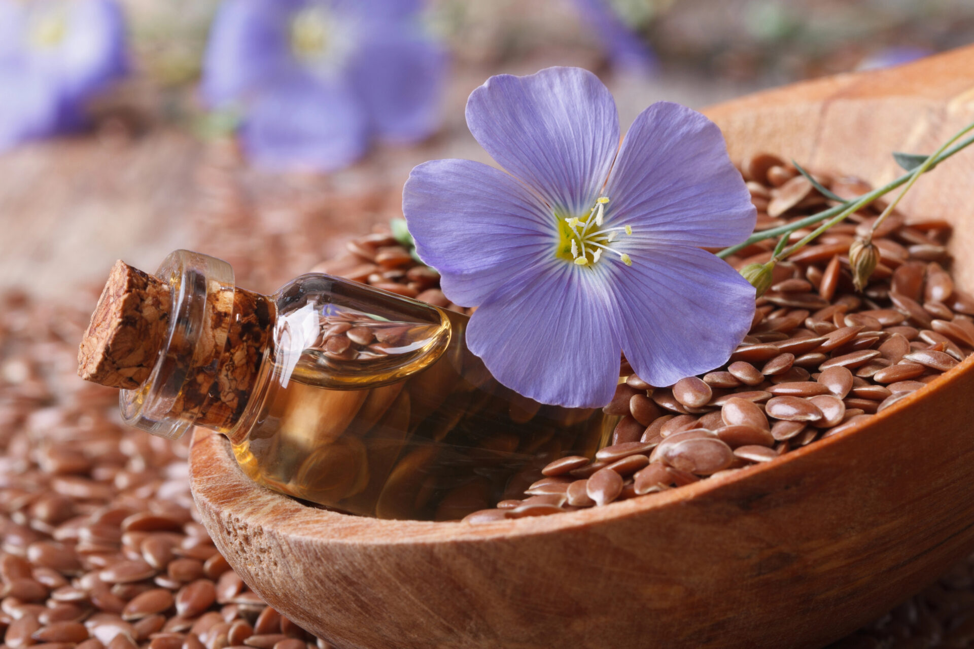 Flaxseeds and flaxseed oil in a wooden bowl