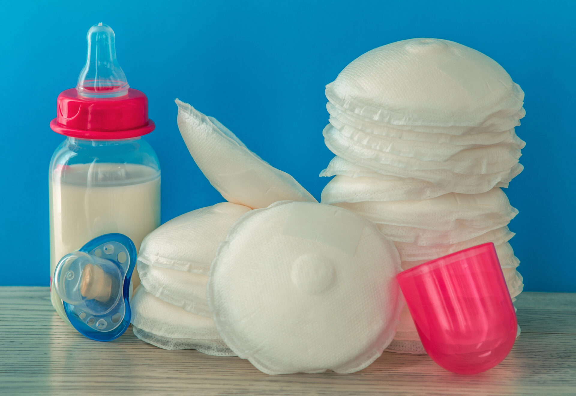 Set of nursing pads and a baby bottle made from plastic