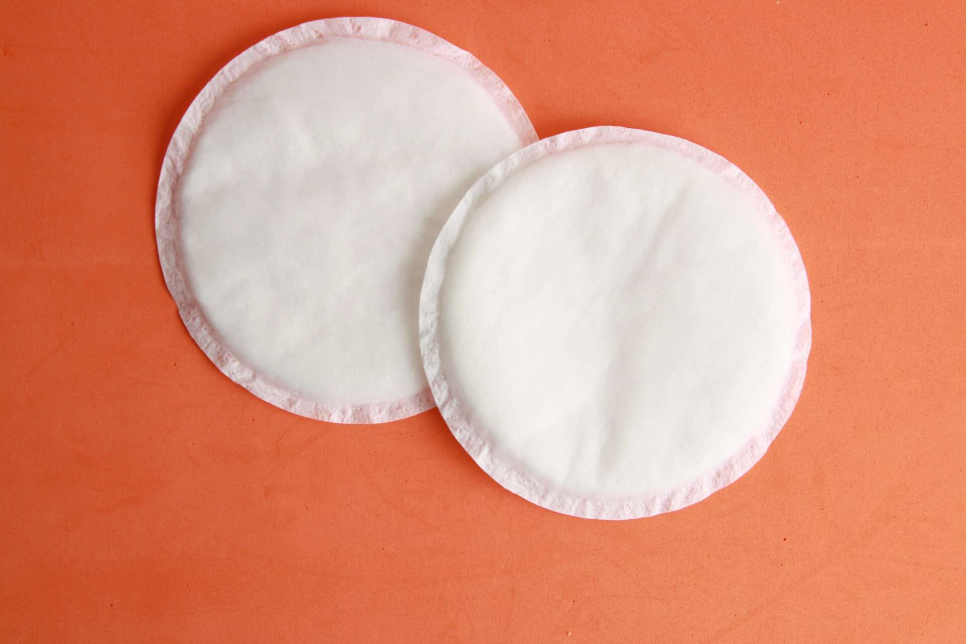 Nursing Pads Tested For Indications of PFAS "Forever Chemicals" on an orange table