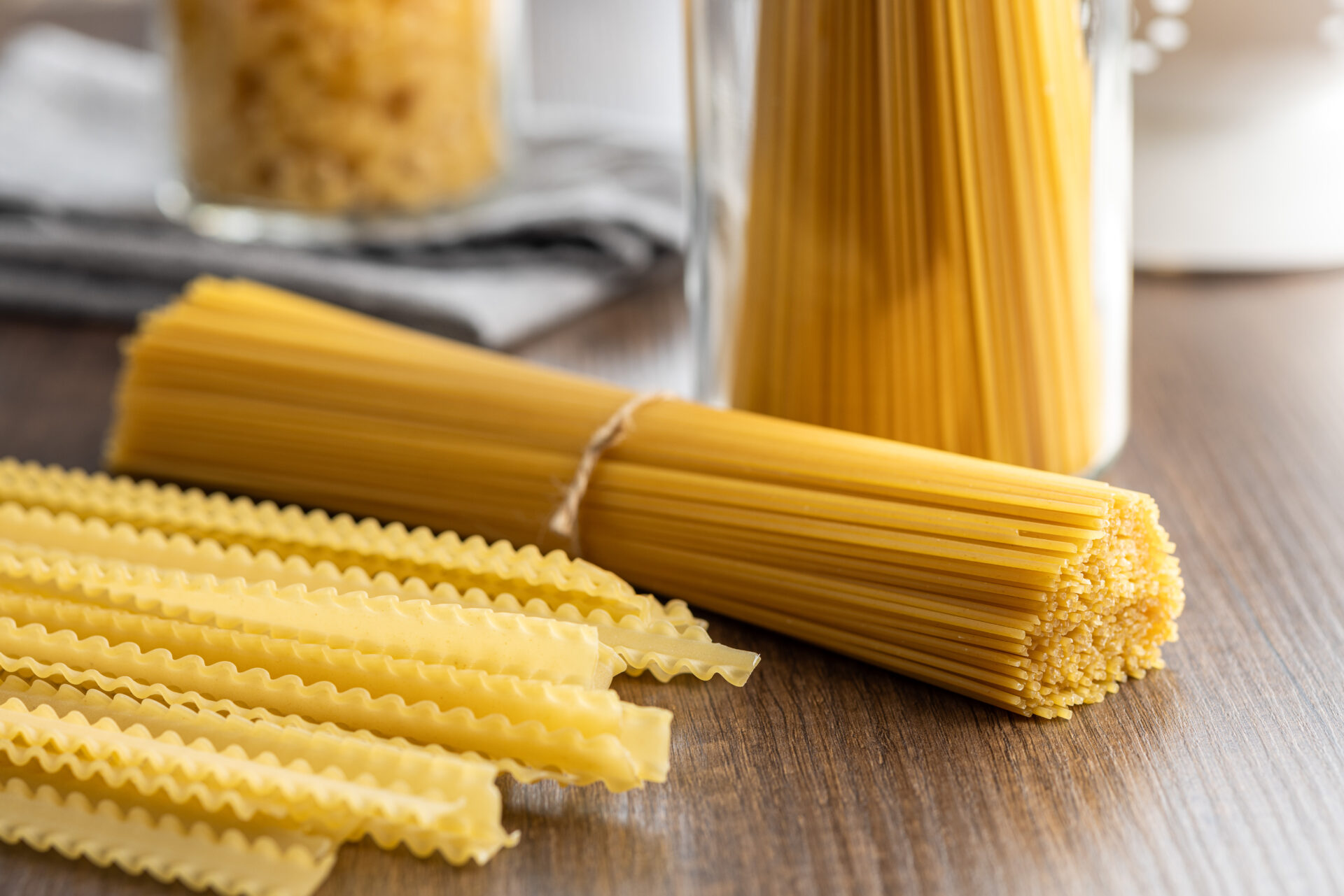 Spaghetti and mafaldine pasta. Uncooked italian pasta on a wooden table.