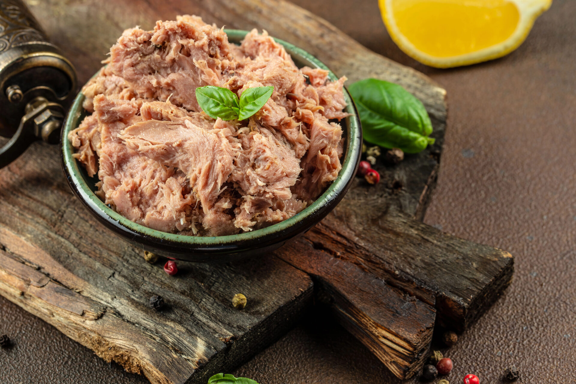 Tuna from a can in a bowl on a wooden table