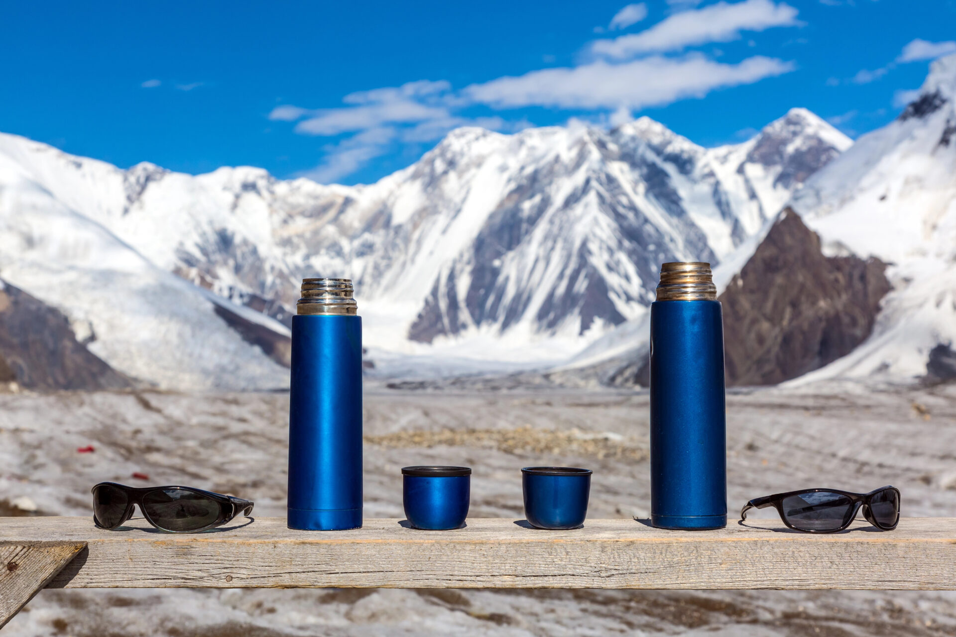 Two mugs sitting side by side with the mountains in the background