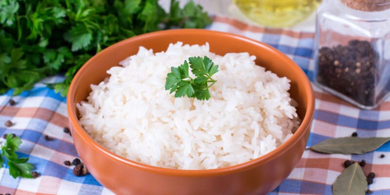 Basmati Rice sitting on the table in a orange ceramic bowl