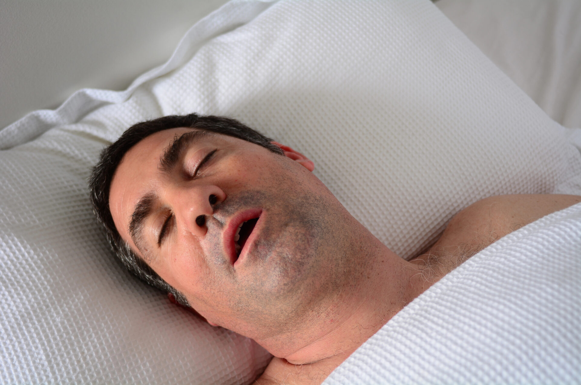 Husband snoring in bed