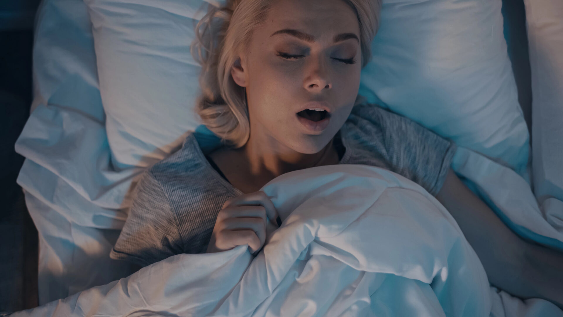 Woman snoring in bed