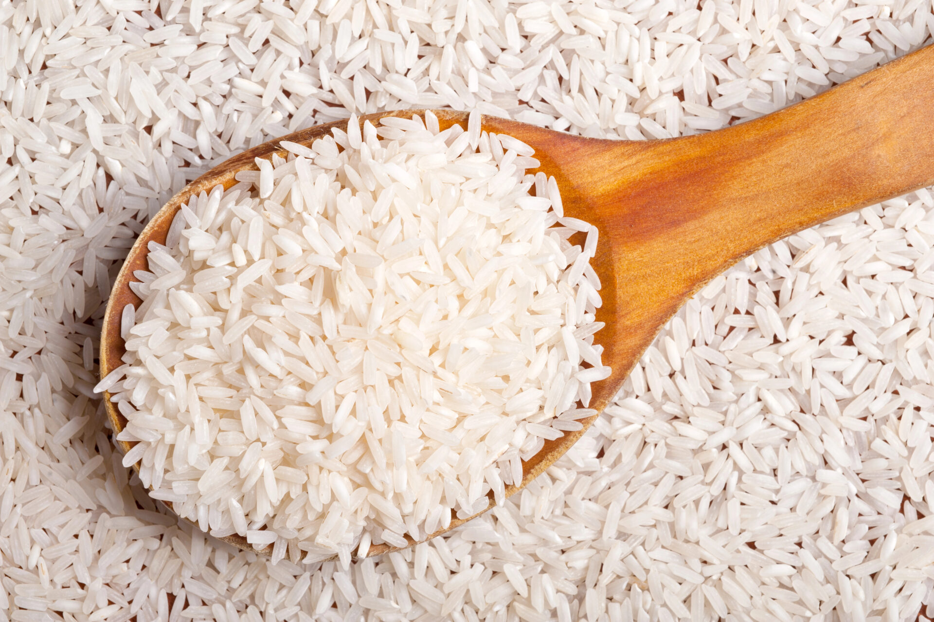Rice background with wooden spoon