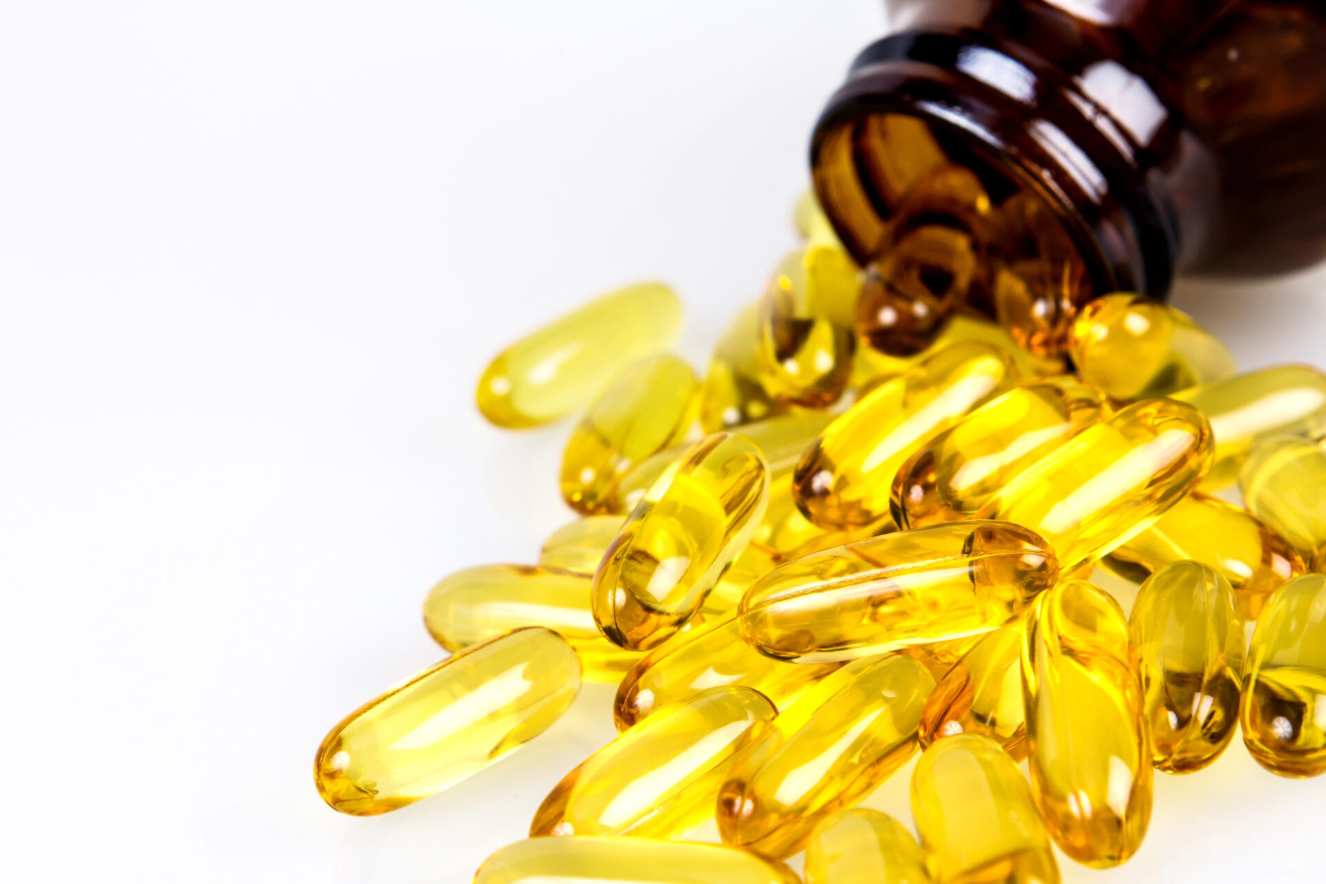 Closeup the yellow soft gelatin supplement fish oil capsule