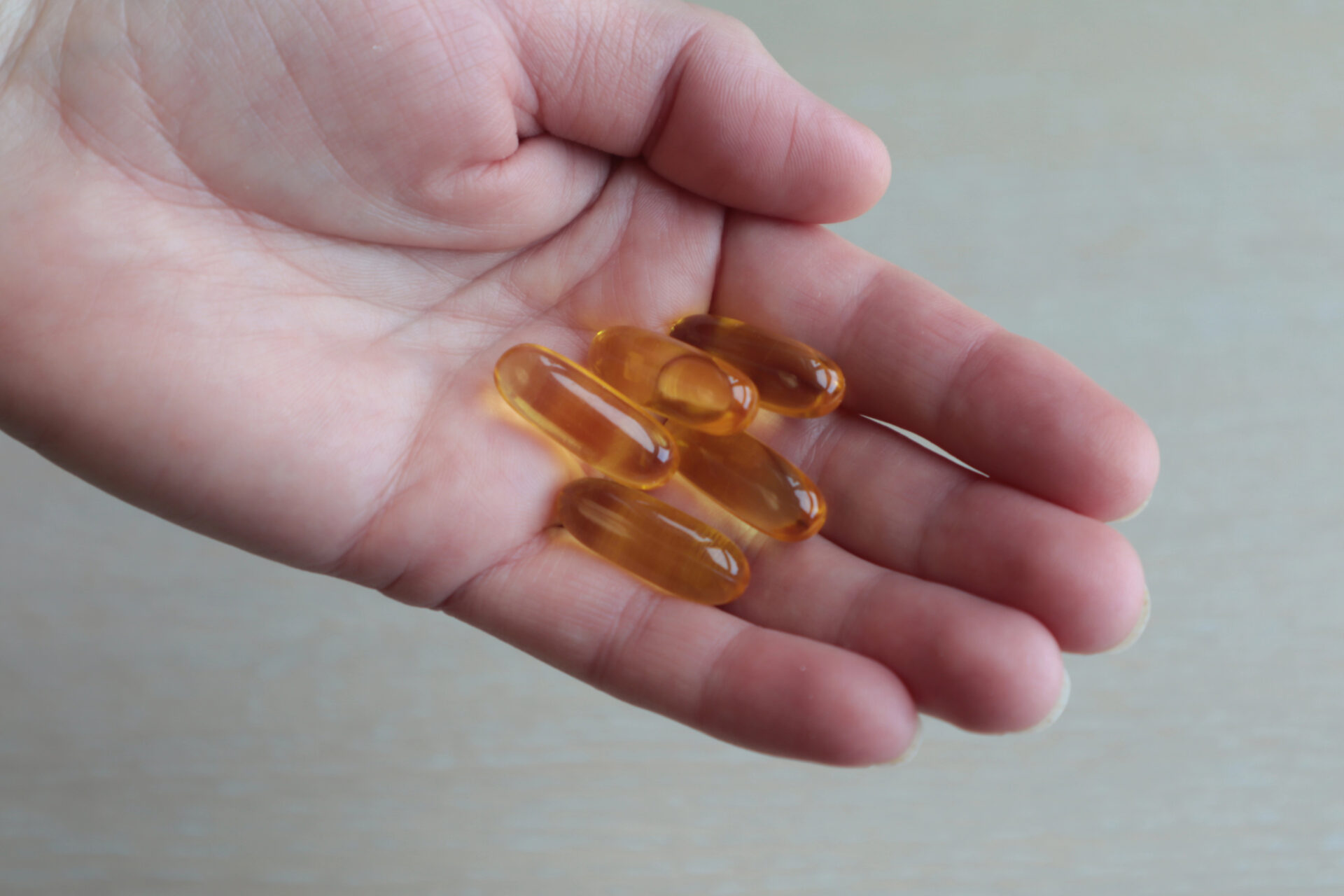 Omega-3s & DHA held in someone's hand