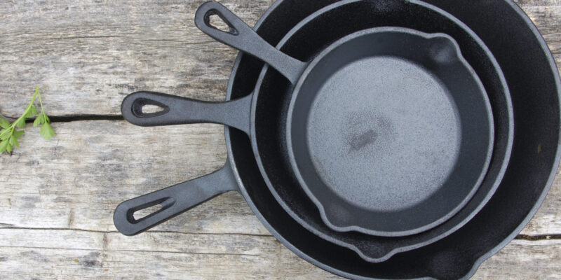 Cast Iron Cookware in threes on a table