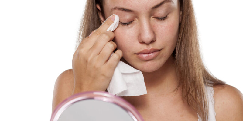 Woman using makeup remover wipe to take off her makeup and dirt