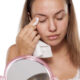 Woman using makeup remover wipe to take off her makeup and dirt